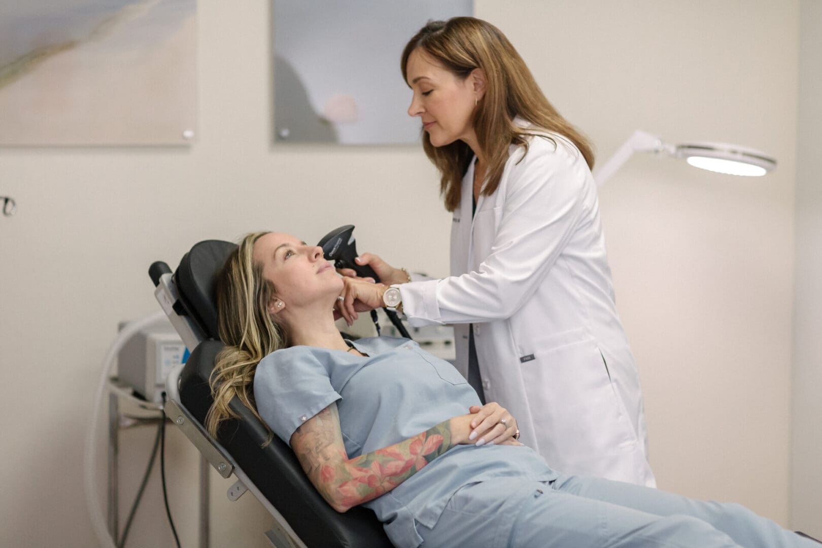 A woman is getting her face examined by a doctor.